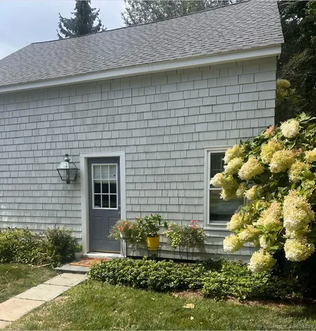 a front view of a house with garden
