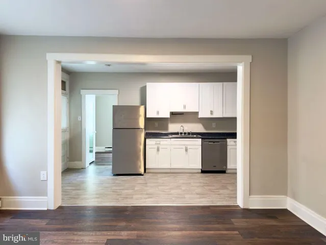 a kitchen with a refrigerator and a stove top oven