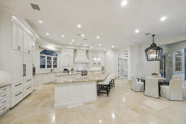 a kitchen with stainless steel appliances granite countertop a sink stove and cabinets