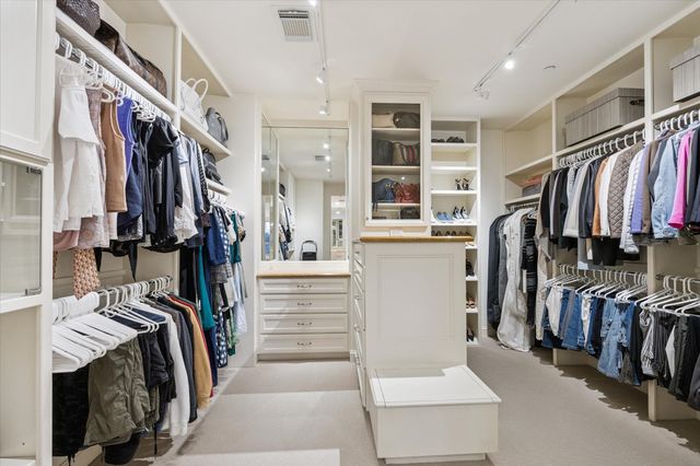 a kitchen with a stove a sink and a refrigerator with wooden floor