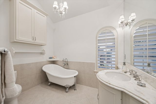 a spacious bedroom with a bed and a window