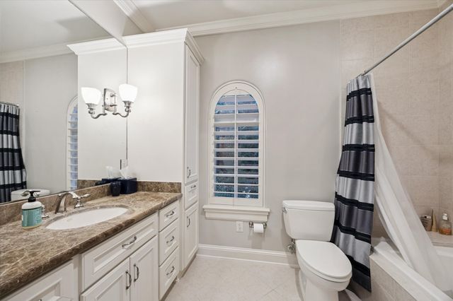 a bedroom with a large bed and a flat screen tv