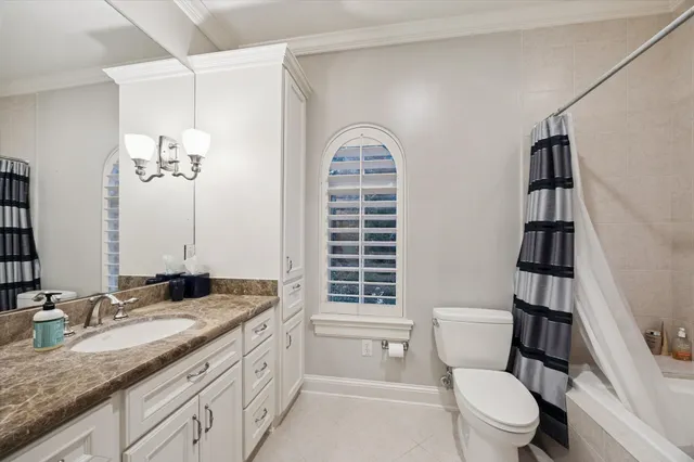 a bedroom with a large bed and a flat screen tv