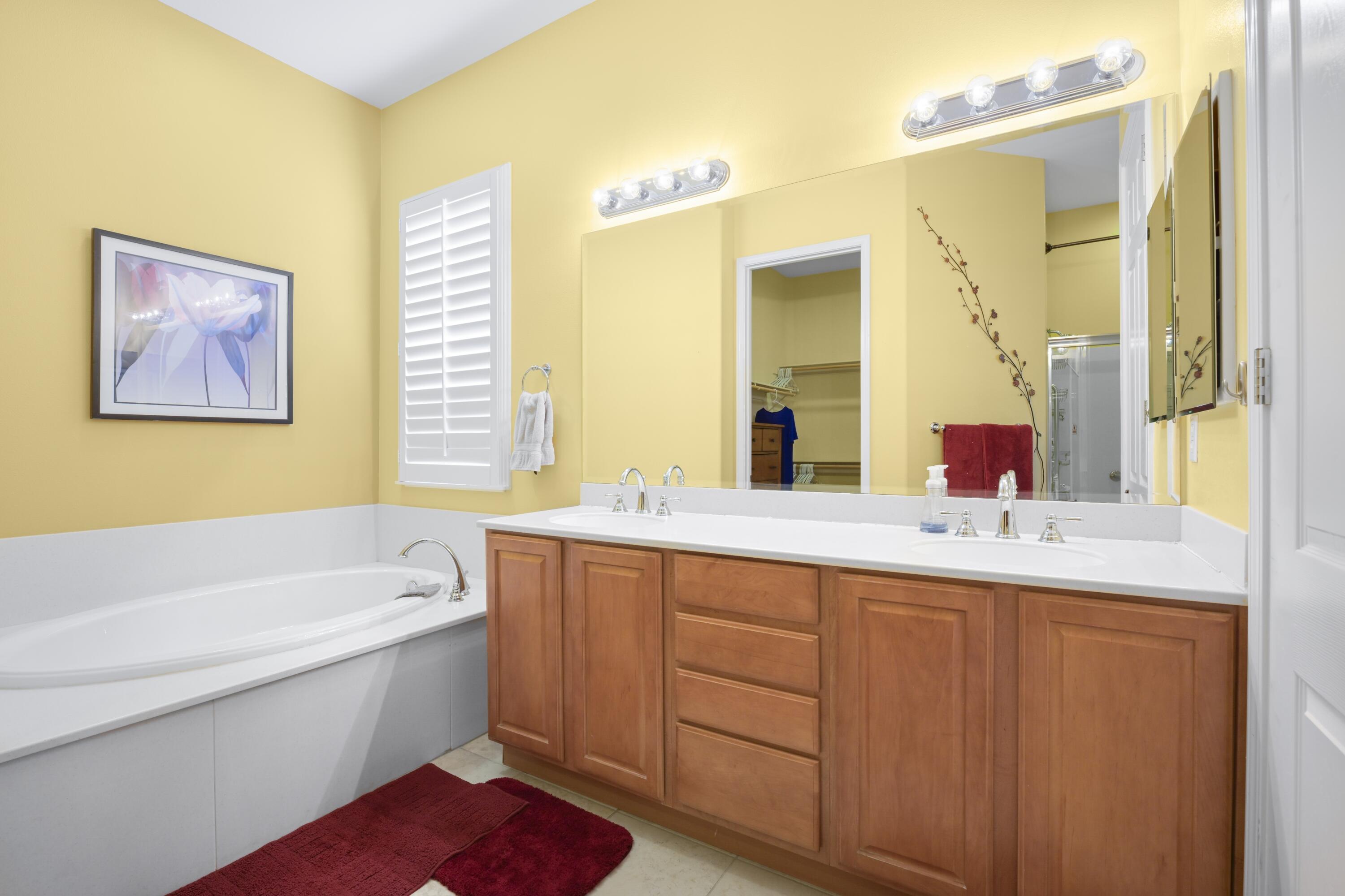 40267 Calle Ebano Indio, CA 92203 - Photo 16 of 48 a bathroom with a tub sink and mirror