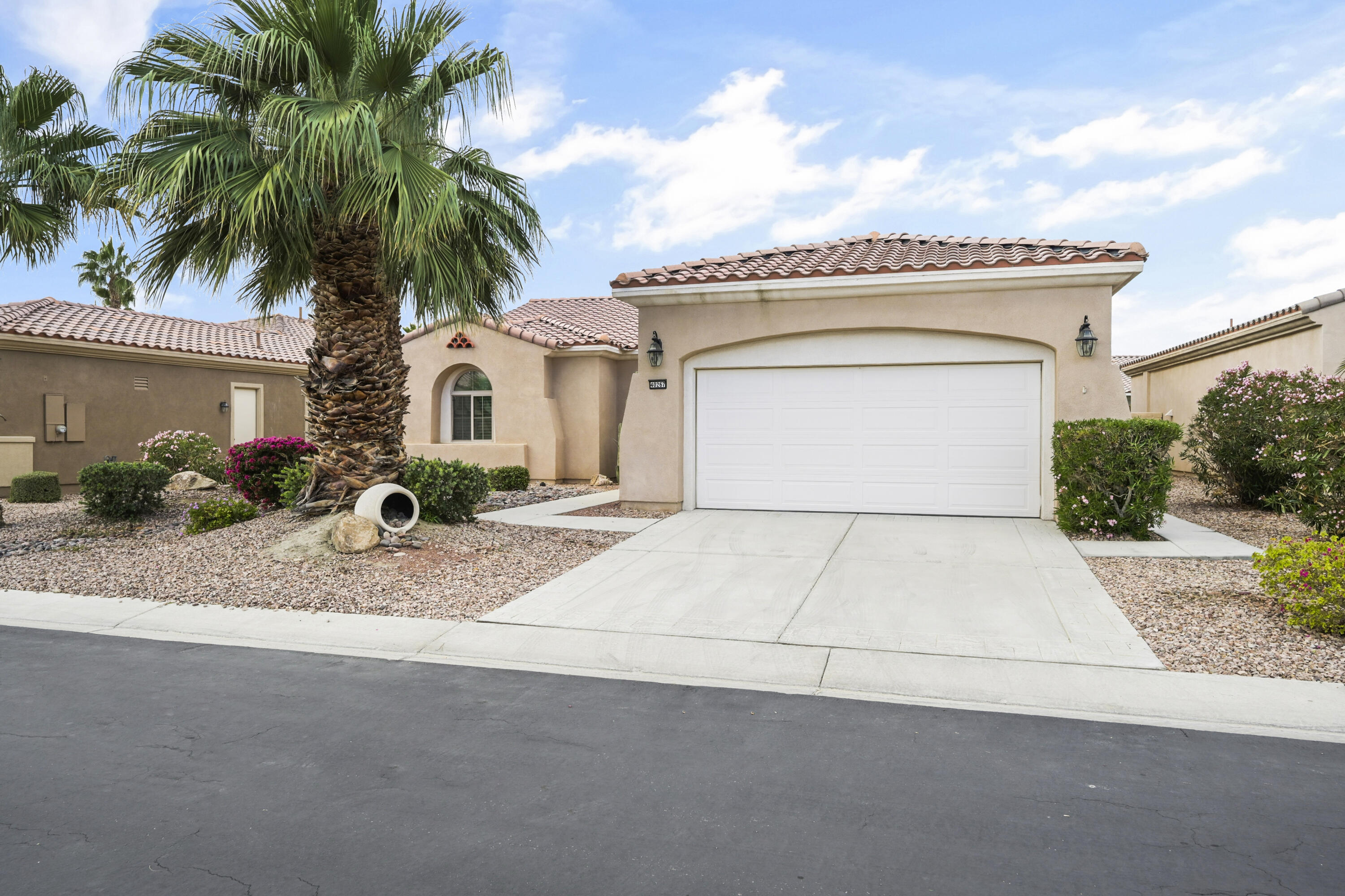 40267 Calle Ebano Indio, CA 92203 - Photo 32 of 48 a view of white house with a yard and palm trees
