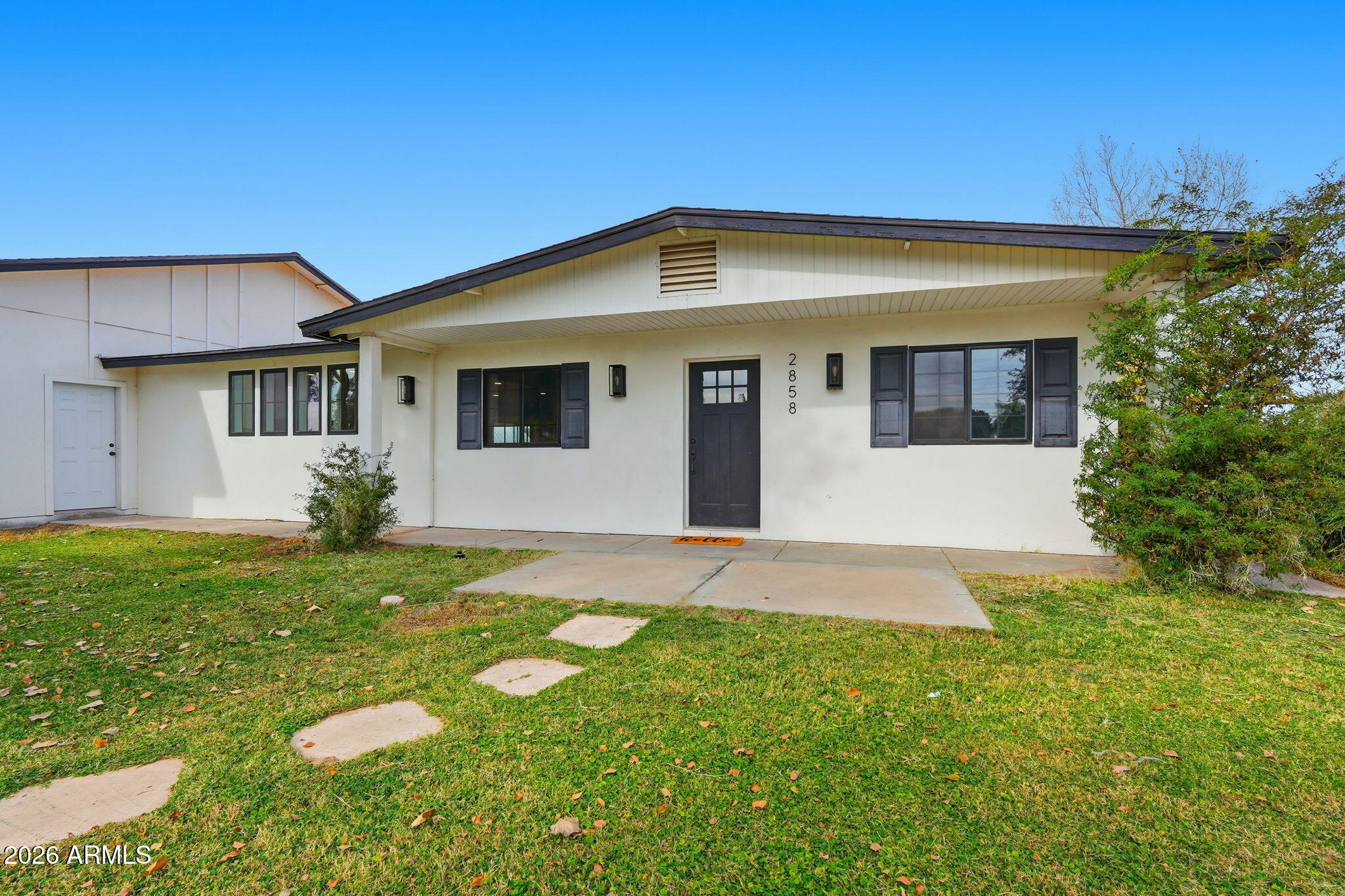 2858 East Redfield Road Gilbert, AZ 85234 - Photo 19 of 60 a front view of a house with a yard