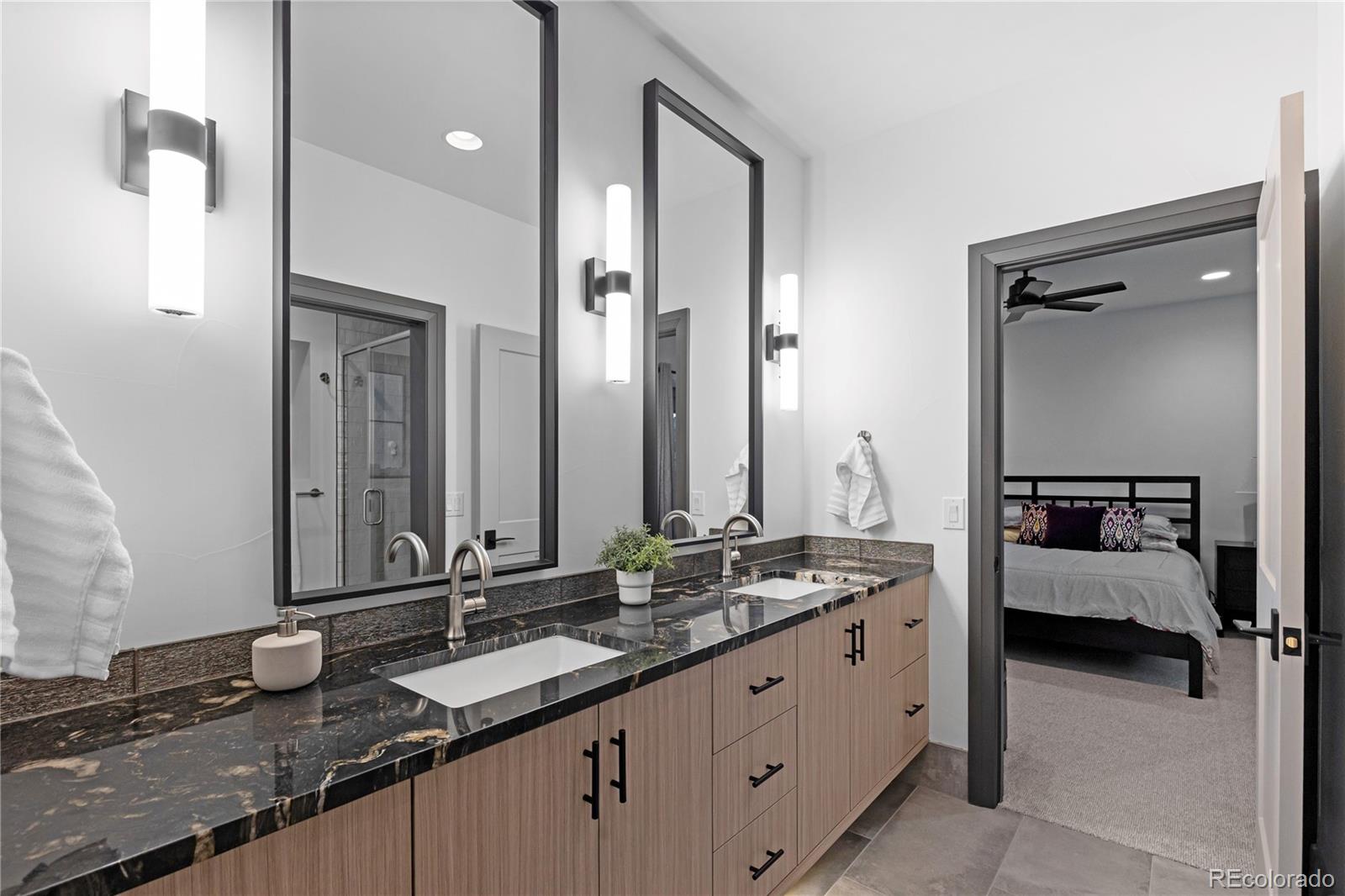 10689 Shadow Pines Road Parker, CO 80138 - Photo 44 of 50 a en suite bathroom with double sink and a mirror