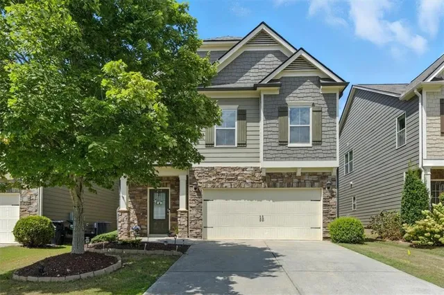 a front view of a house with garden