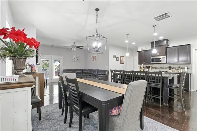 a dining room with furniture and wooden floor
