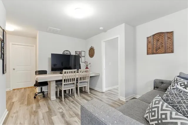 a view of a livingroom with furniture and a flat screen tv