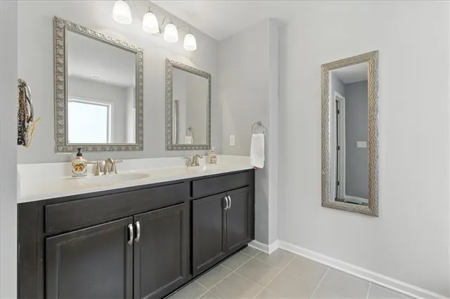 a bathroom with a double vanity sink mirror and