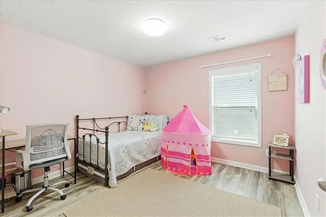 a bedroom with furniture and a flat screen tv