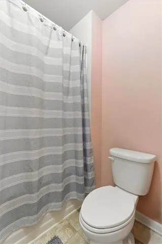 a white toilet sitting next to a bathroom sink