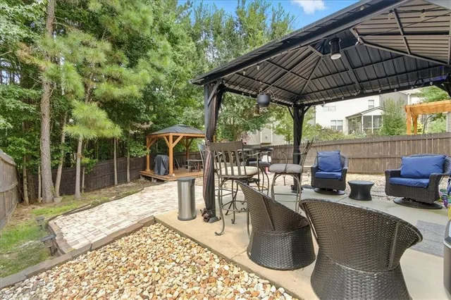 a view of roof deck with table and chairs under an umbrella