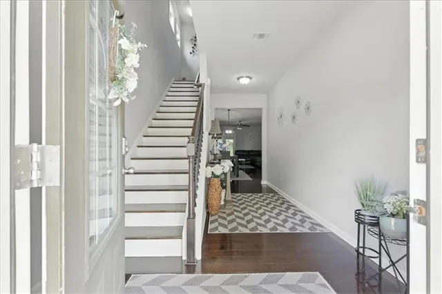 a view of entryway and hall with wooden floor