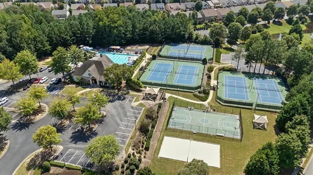 an aerial view of a house with a yard and large trees