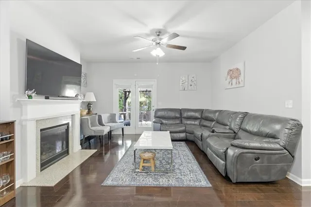 a living room with furniture a flat screen tv and a fireplace