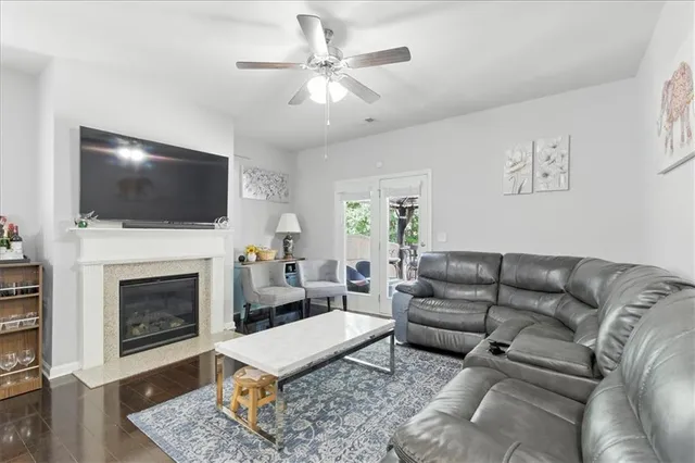 a living room with furniture a fireplace and a flat screen tv
