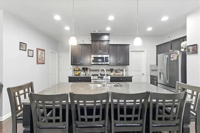 a large kitchen with a table and chairs