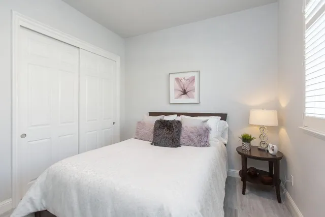 a bedroom with a bed and a window