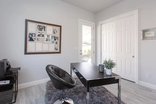 a workspace with furniture and a potted plant
