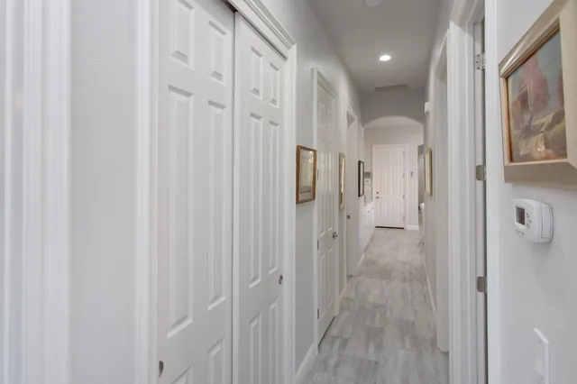 a view of a hallway with wooden floor
