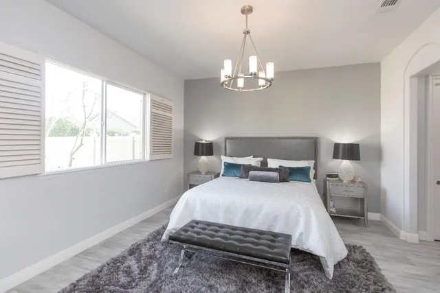 a bedroom with bed and window