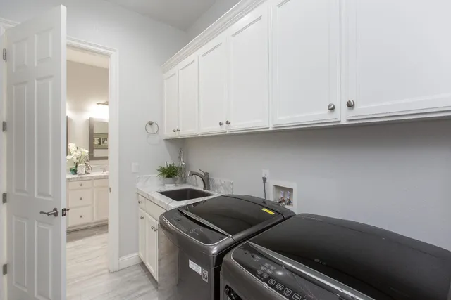a kitchen with a stove and white cabinets