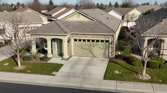 an aerial view of a house with a yard