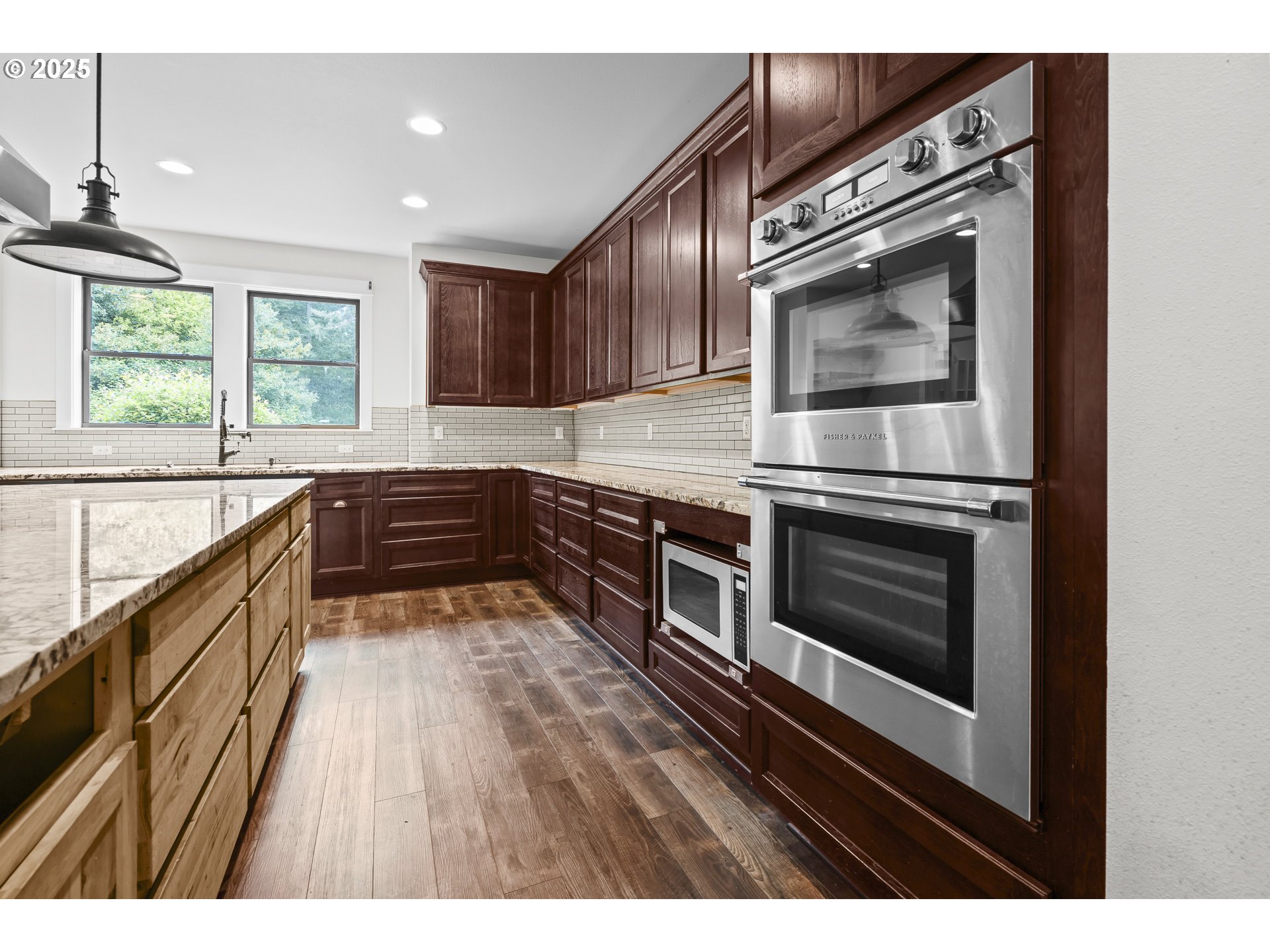 39665 Southeast Rude Road Sandy, OR 97055 - Photo 12 of 48 a kitchen with stainless steel appliances kitchen island granite countertop a stove and a microwave