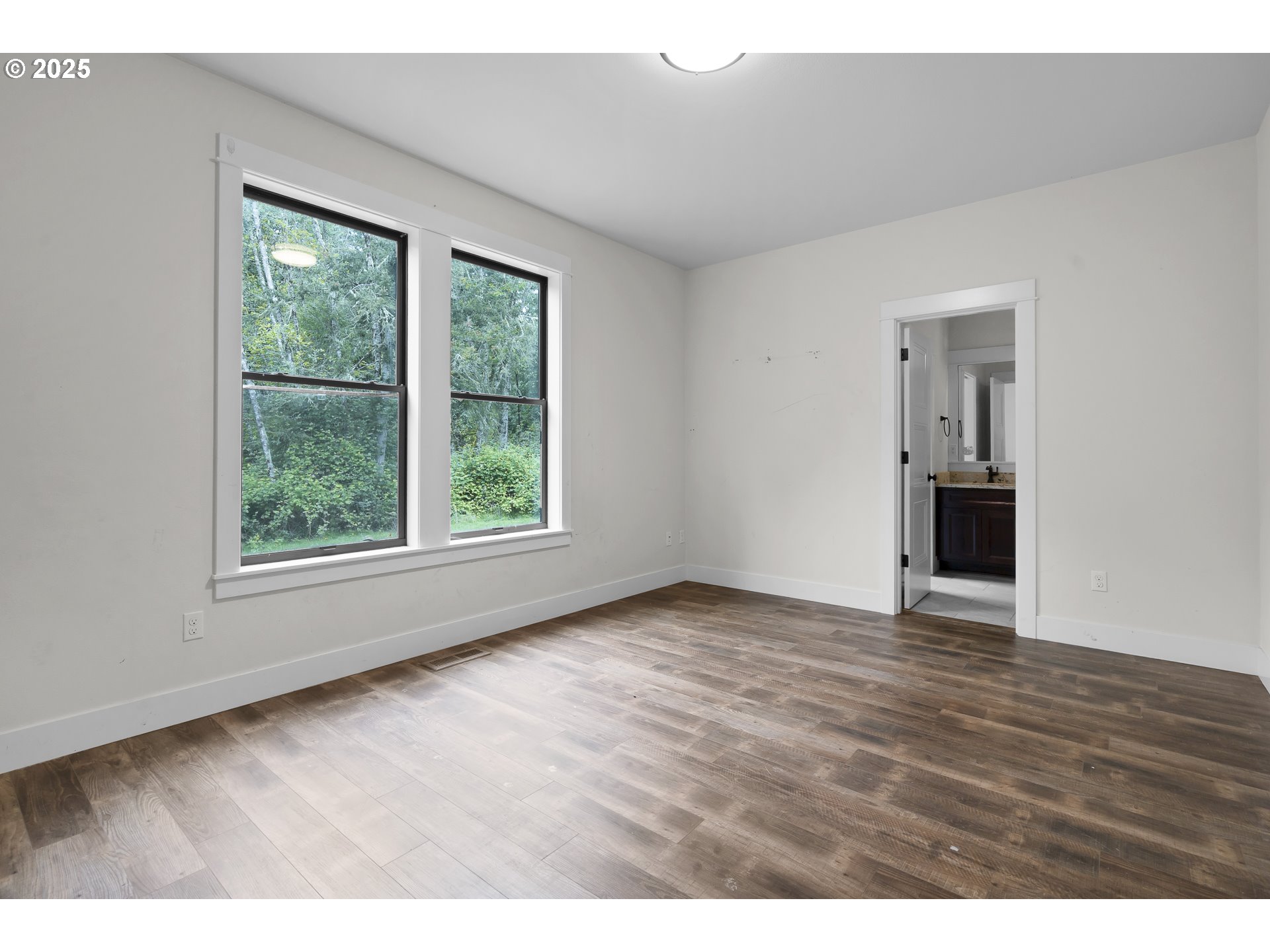 39665 Southeast Rude Road Sandy, OR 97055 - Photo 26 of 48 a view of an empty room with wooden floor and a window