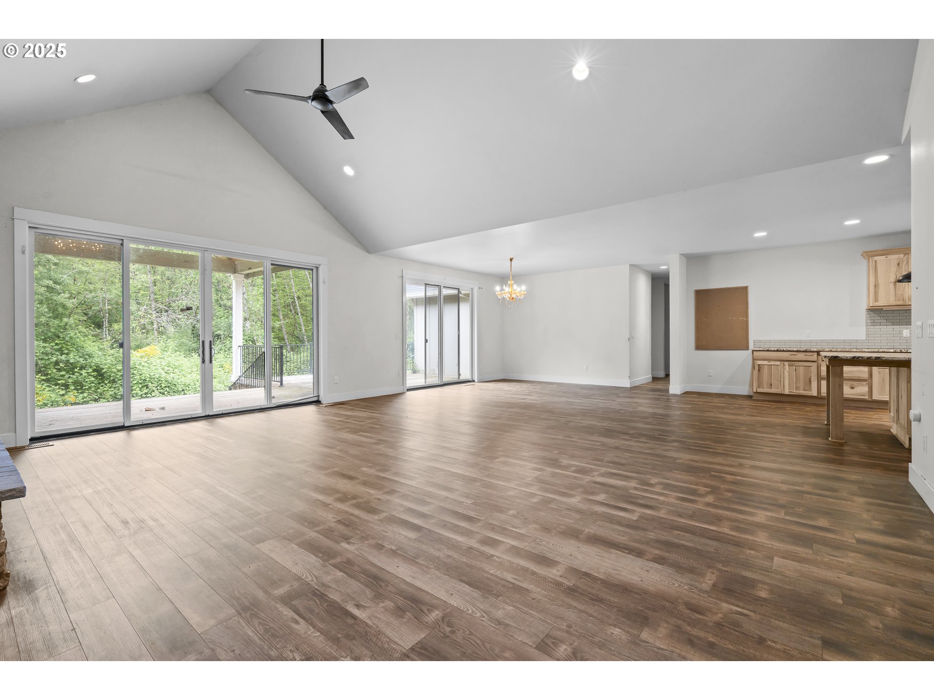 39665 Southeast Rude Road Sandy, OR 97055 - Photo 4 of 48 a view of an empty room with wooden floor and a window