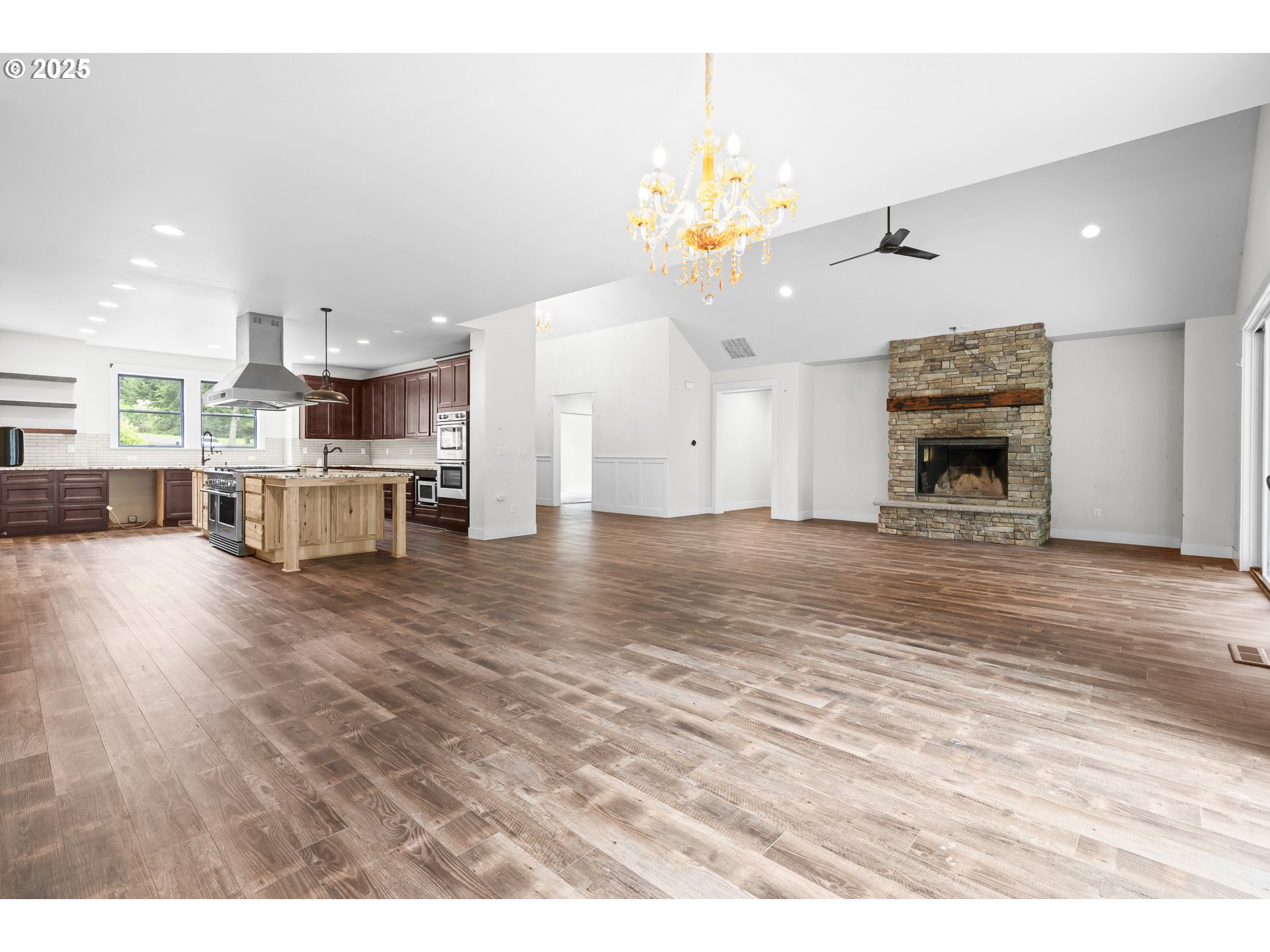 39665 Southeast Rude Road Sandy, OR 97055 - Photo 9 of 48 a view of a living room and a kitchen with furniture wooden floor kitchen view
