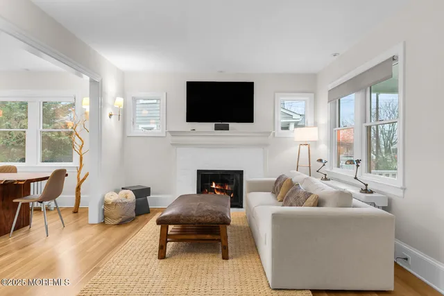 a living room with furniture fireplace and flat screen tv