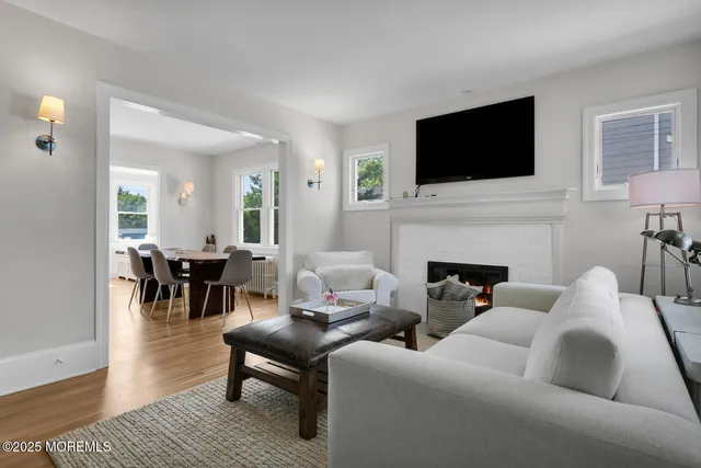 a living room with furniture fireplace and flat screen tv
