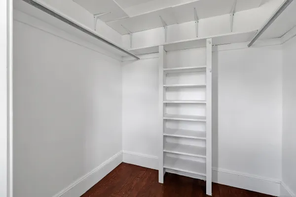a view of walk in closet with empty racks