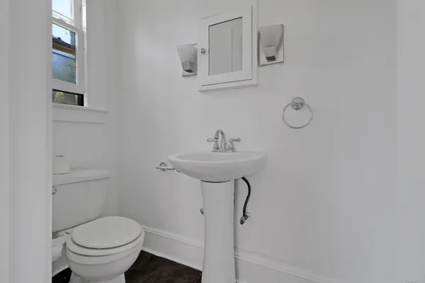 a bathroom with a sink toilet and a mirror