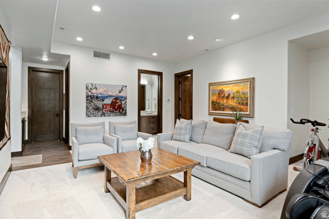 11547 Soaring Hawk Lane Hideout, UT 84036 - Photo 31 of 43 Carpeted living area featuring recessed lighting, a built-in wall niche, and dark wood-finish doors