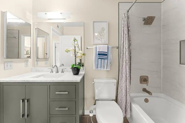 a bathroom with a sink toilet vanity and shower