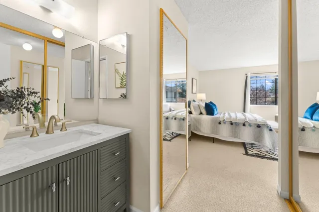 a en suite bathroom with a double vanity sink and mirror