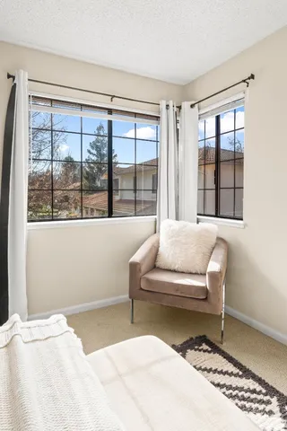 a bedroom with a bed and a large window
