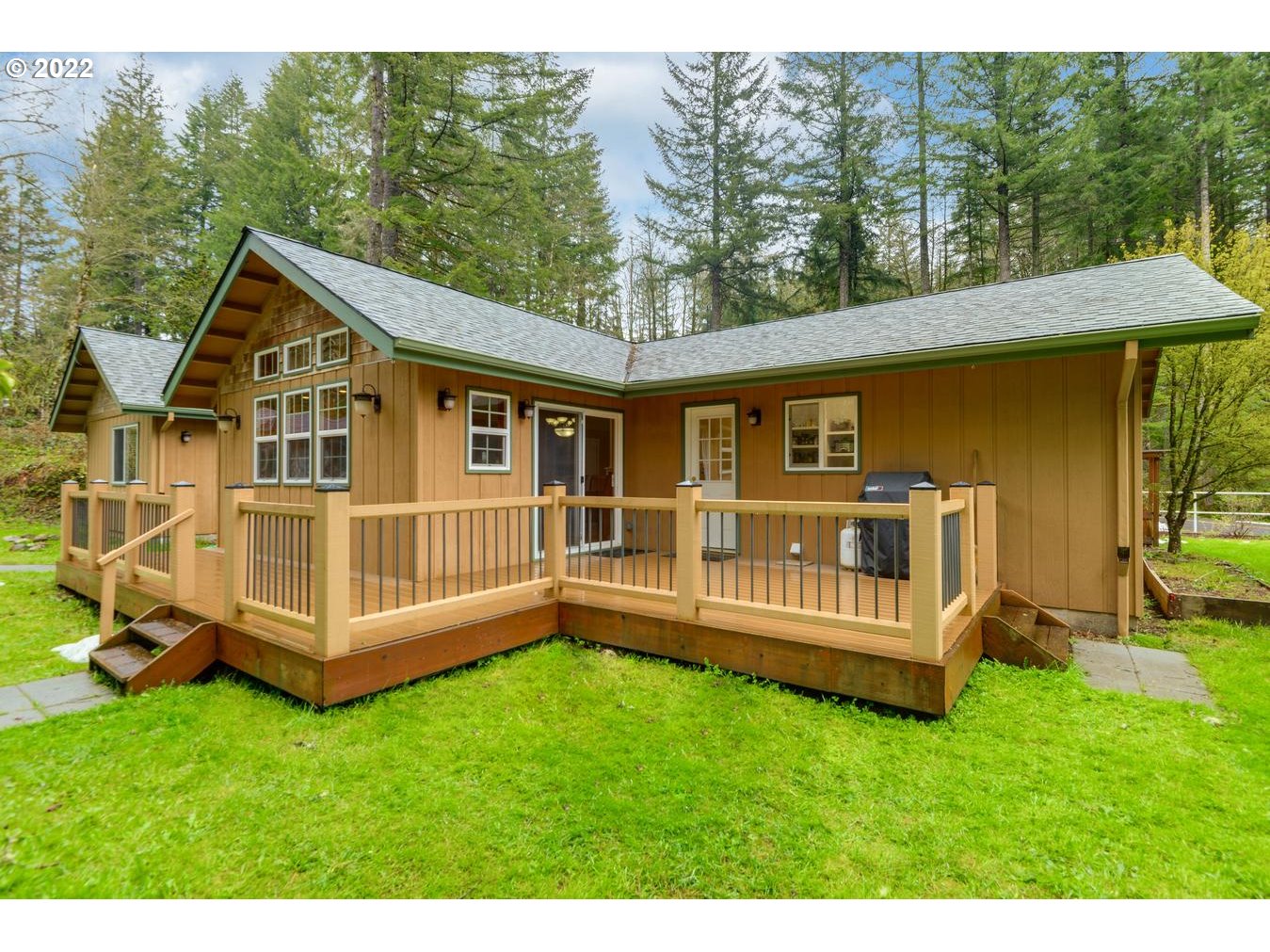 23767 Southeast McCabe Road Sandy, OR 97055 - Photo 3 of 32 a view of a house with a backyard and wooden deck
