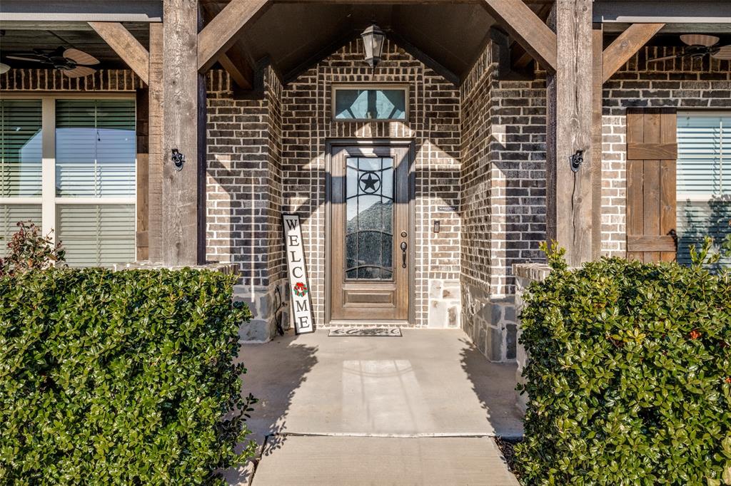 7417 Green Mesa Road Ponder, TX 76259 - Photo 2 of 39 a front view of a house with a garden