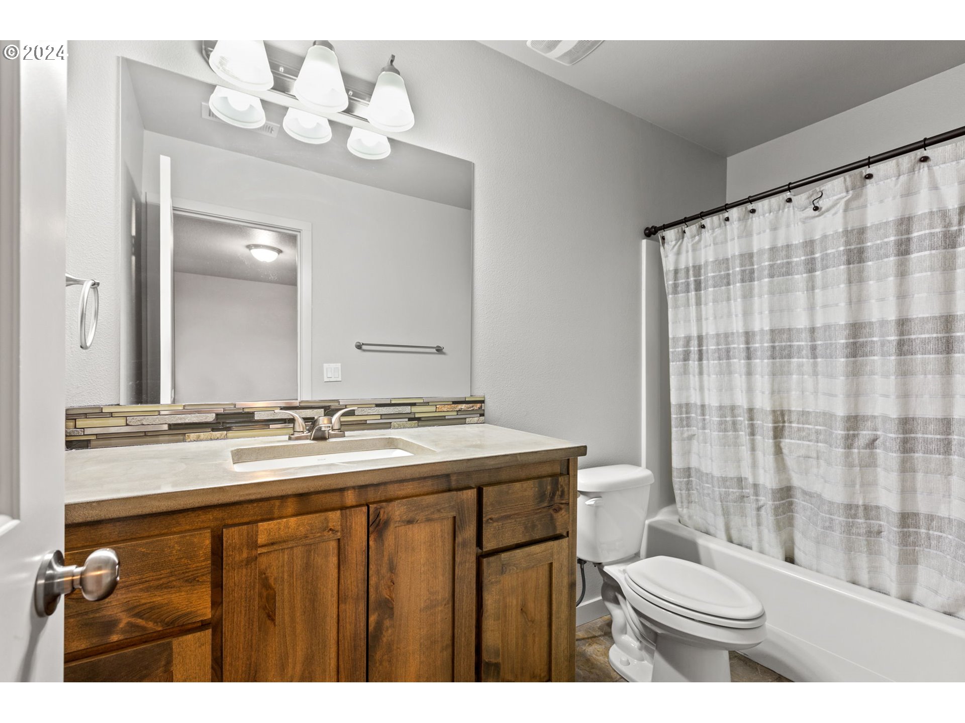 117 North 44th Place Ridgefield, WA 98642 - Photo 28 of 30 a bathroom with a sink vanity mirror and toilet