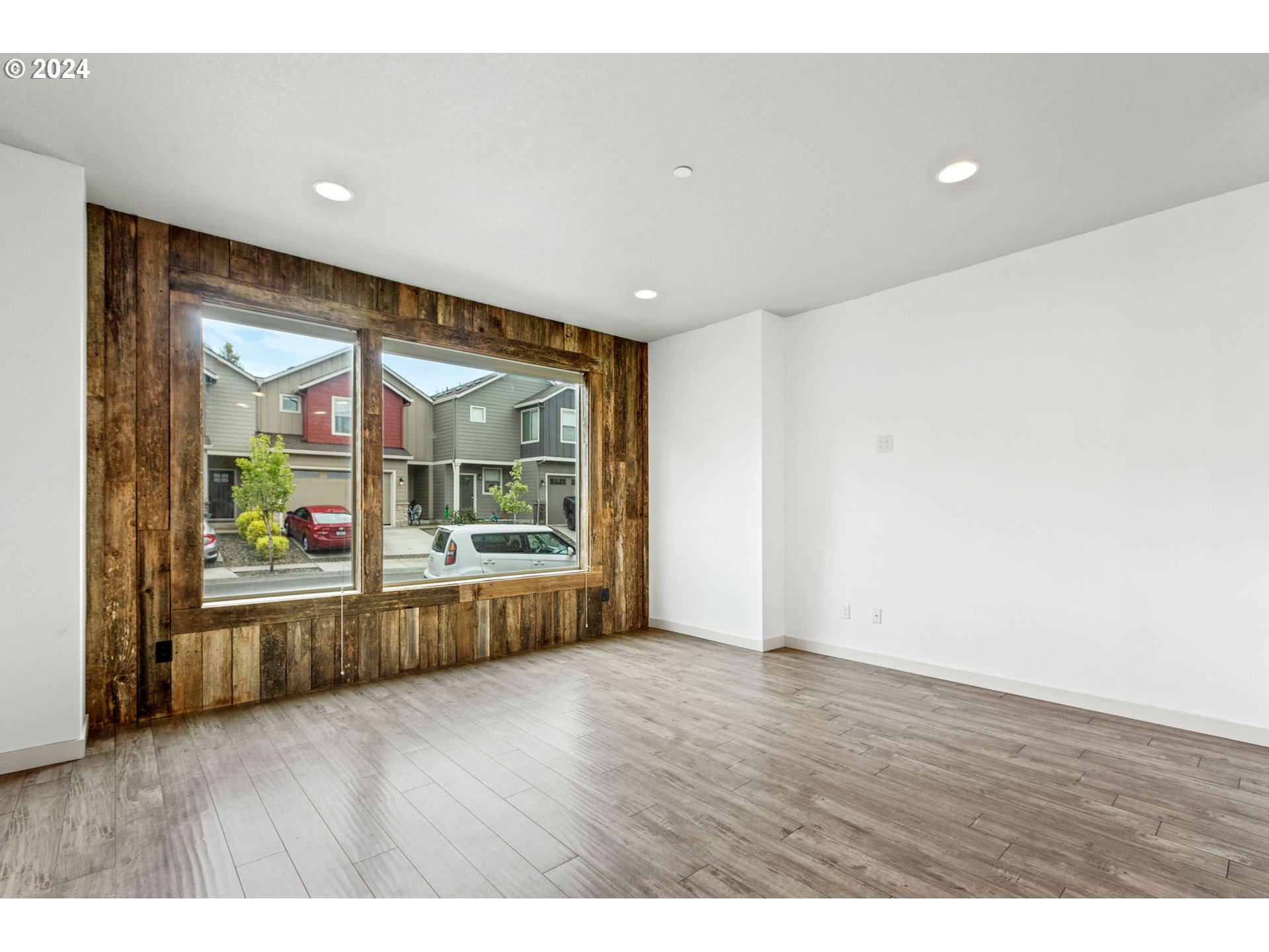 117 North 44th Place Ridgefield, WA 98642 - Photo 8 of 30 an empty room with wooden floor and windows