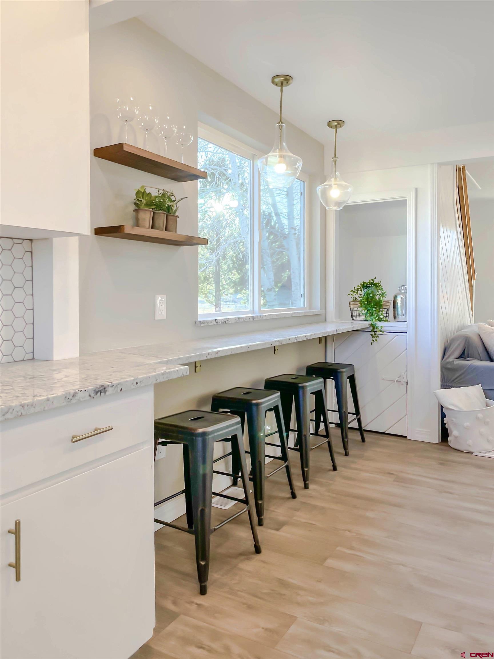 4956 1550 Road Delta, CO 81416 - Photo 17 of 35 a kitchen with a table chairs sink and cabinets