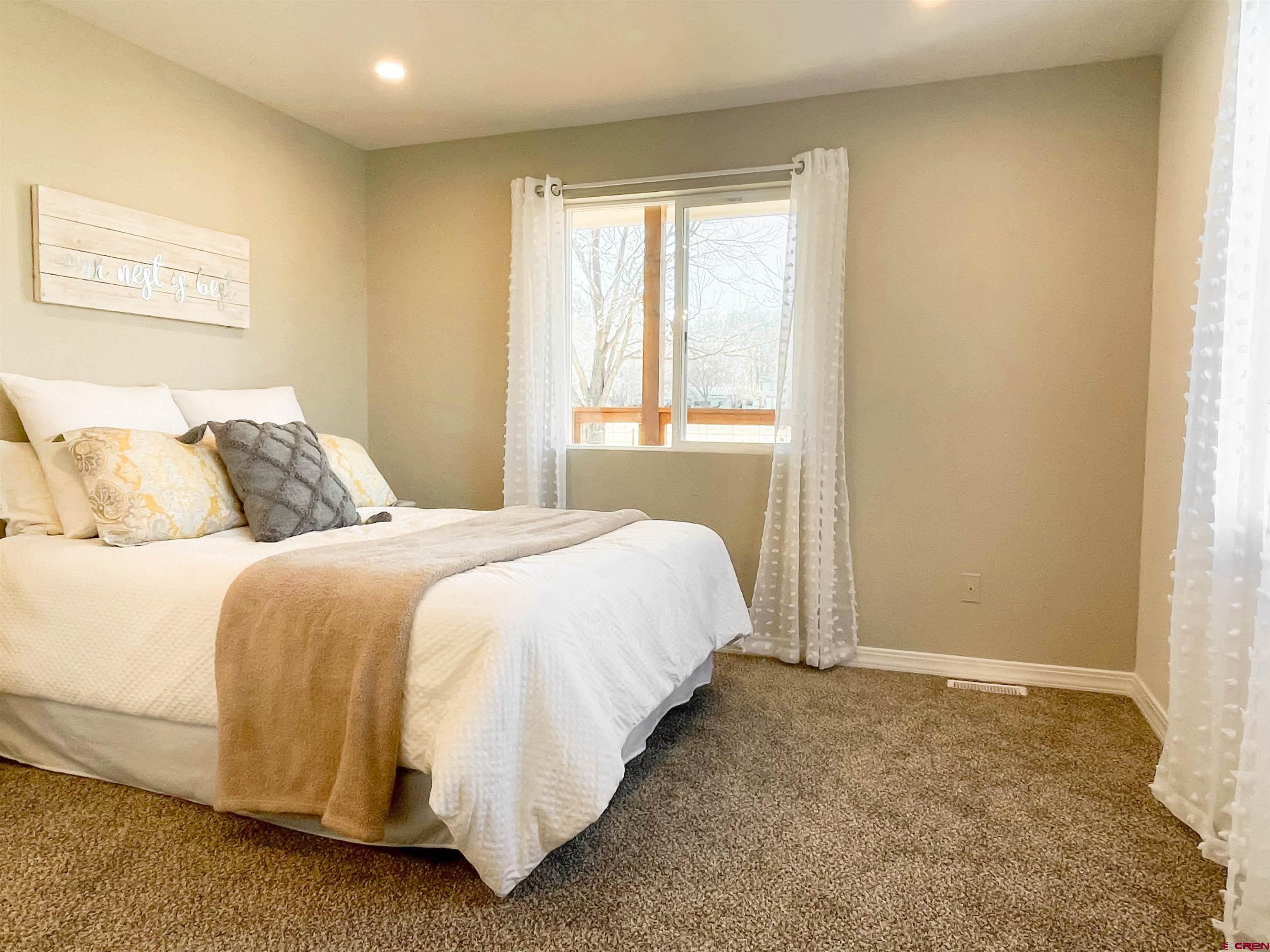 4956 1550 Road Delta, CO 81416 - Photo 20 of 35 a bedroom with a bed and a window