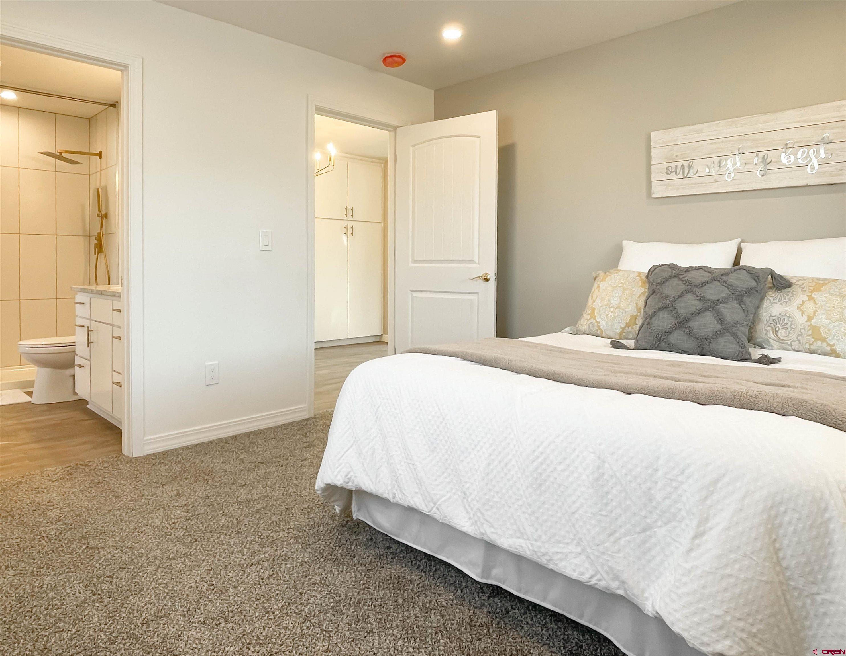 4956 1550 Road Delta, CO 81416 - Photo 21 of 35 a bedroom with a bed and walk in closet