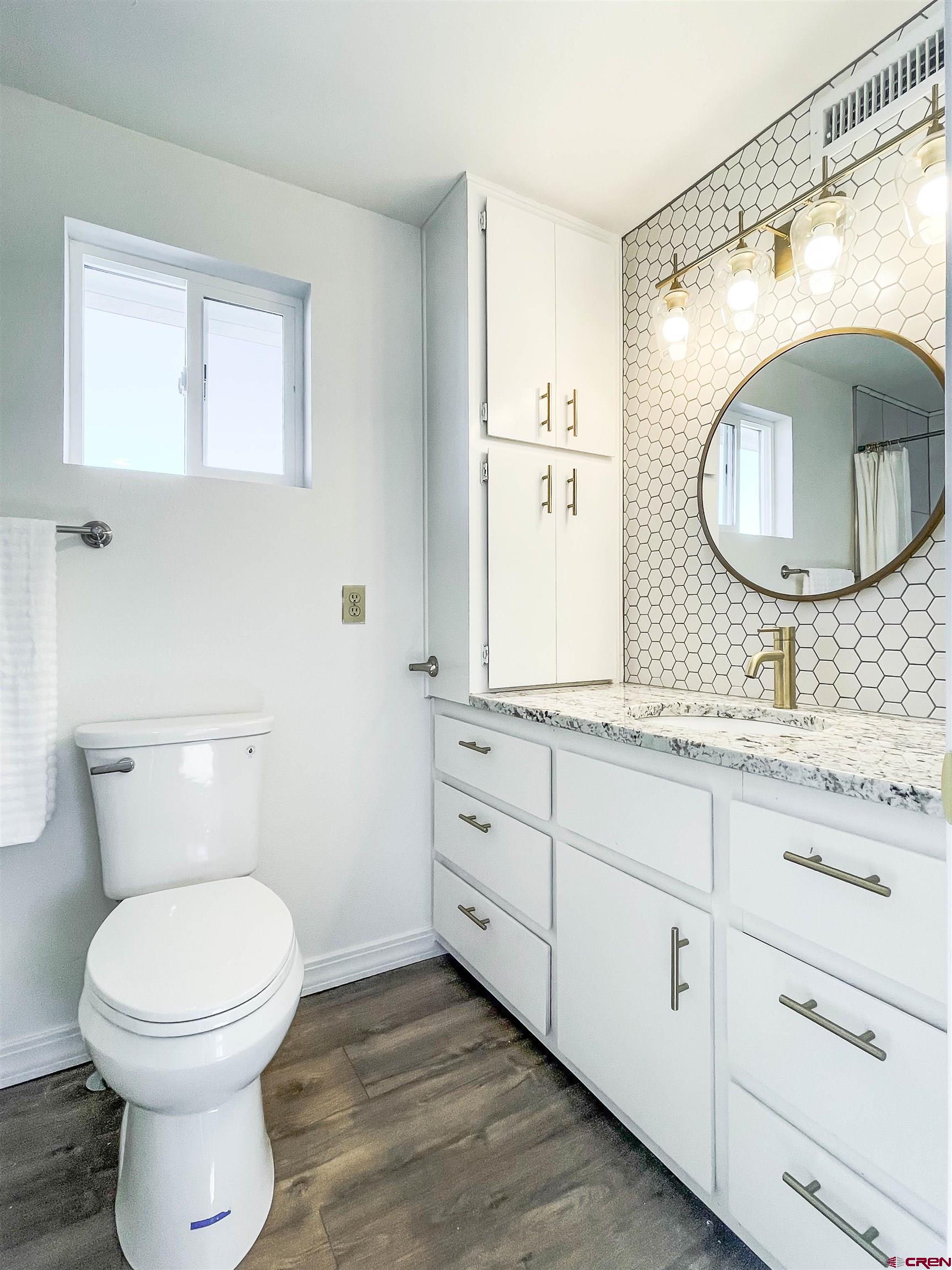 4956 1550 Road Delta, CO 81416 - Photo 28 of 35 a bathroom with a toilet a sink and mirror