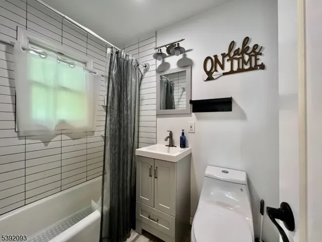 a bathroom with a sink a mirror and a bathtub